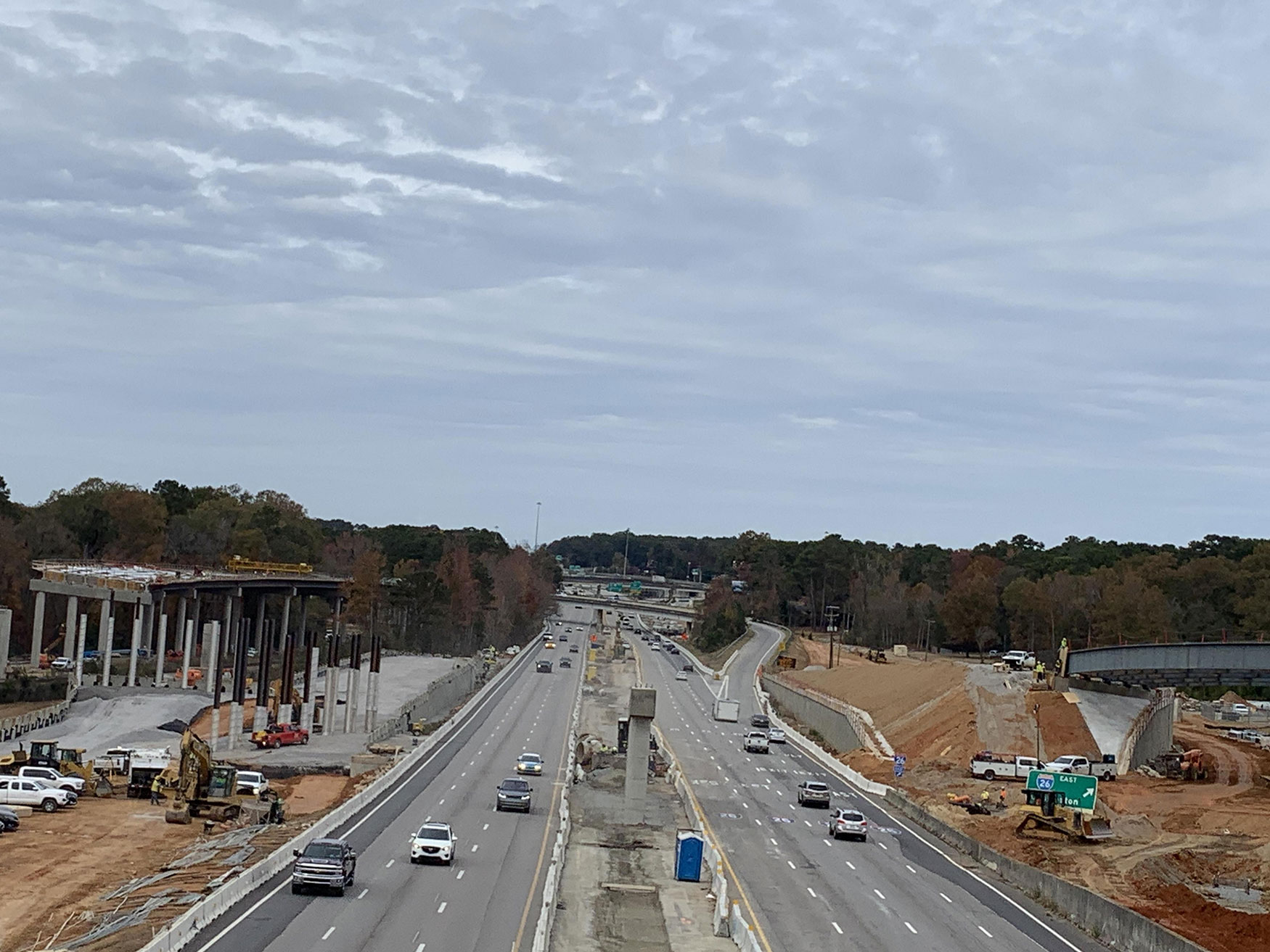 Looking West along the centerline of I-126 towards Spartanburg, the construction of three new bridges can be seen. Bridge 35, over the Saluda River, is on the left side of the photo. Bridge 34 with steel girders is on the right. Bridge 36 Bent 2  is located in the median of I-126 at the center.