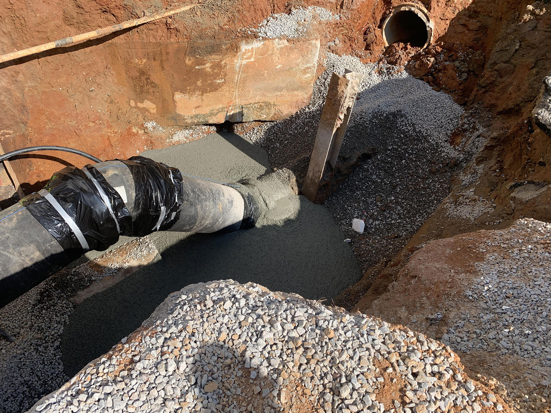 A 42" waterline tie-in on Arrowhead Road is being relocated to accommodate evolving infrastructure and minimize disruptions to water supply and transportation systems during highway construction.