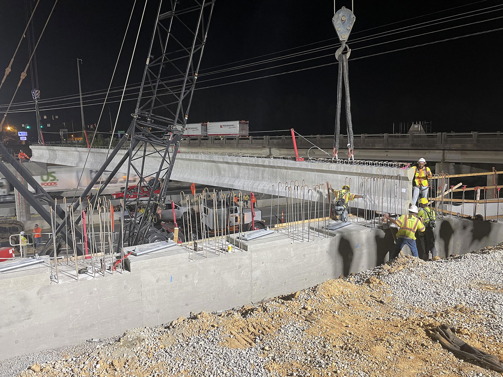 Construction crew members helping set a concrete girder. These girders will provide support for the new bridge over I-20 along Broad River Road.  
