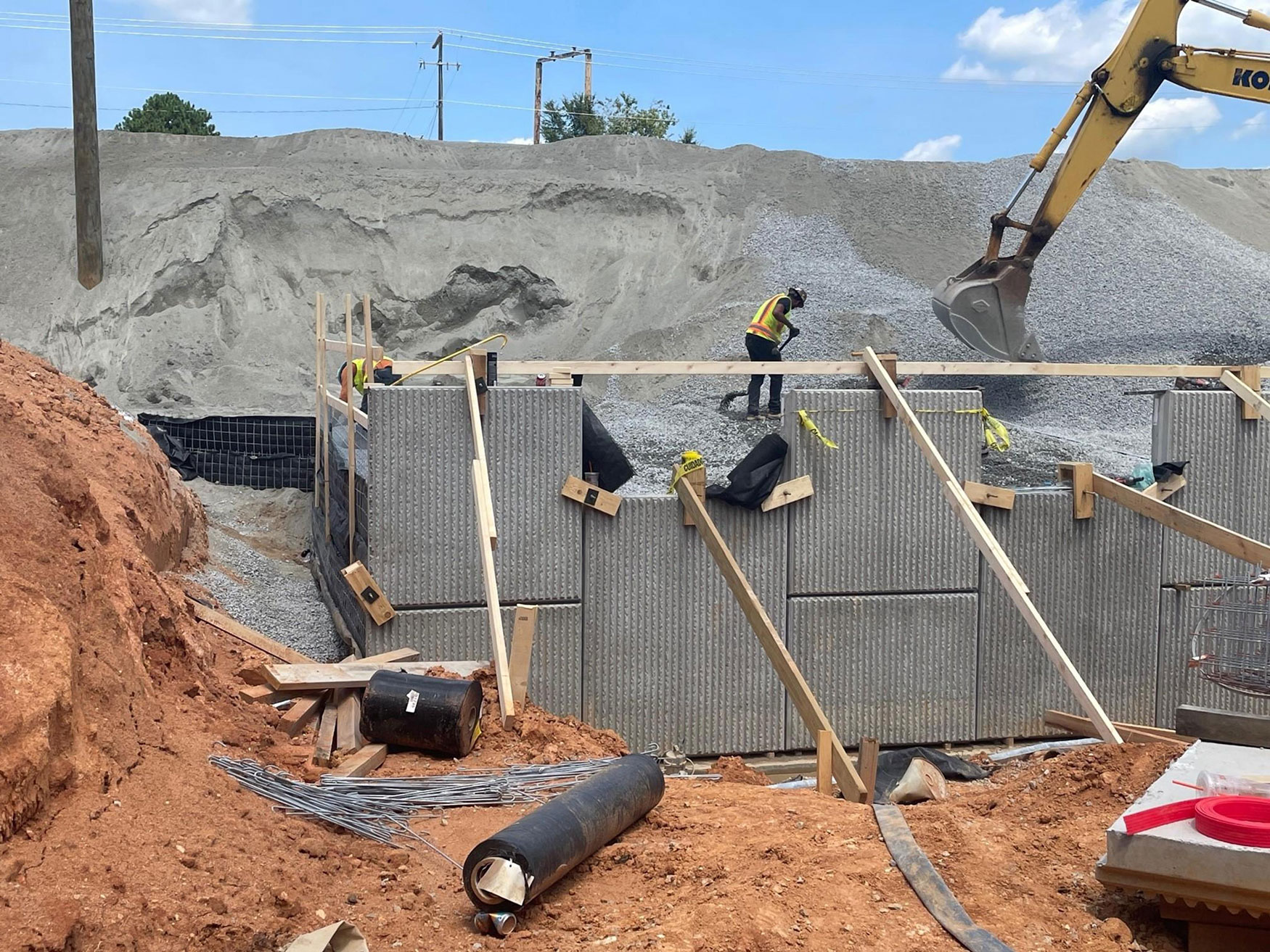Early stages of a retaining wall being built near Broad River Road in August 2023. A Mechanically Stabilized Earth (MSE) retaining wall will keep soil in place along high-volume traffic areas.